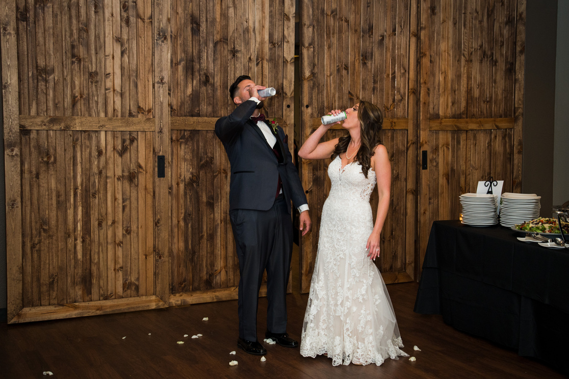 A bride and groom toasting at their wedding reception.